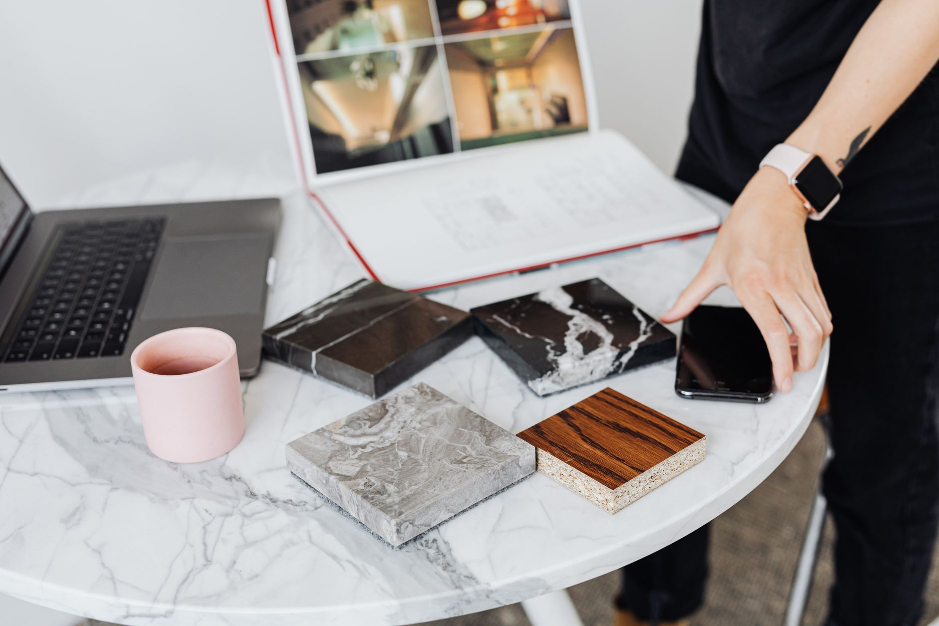 Material samples laid on a marble table in the Maison Verte studio